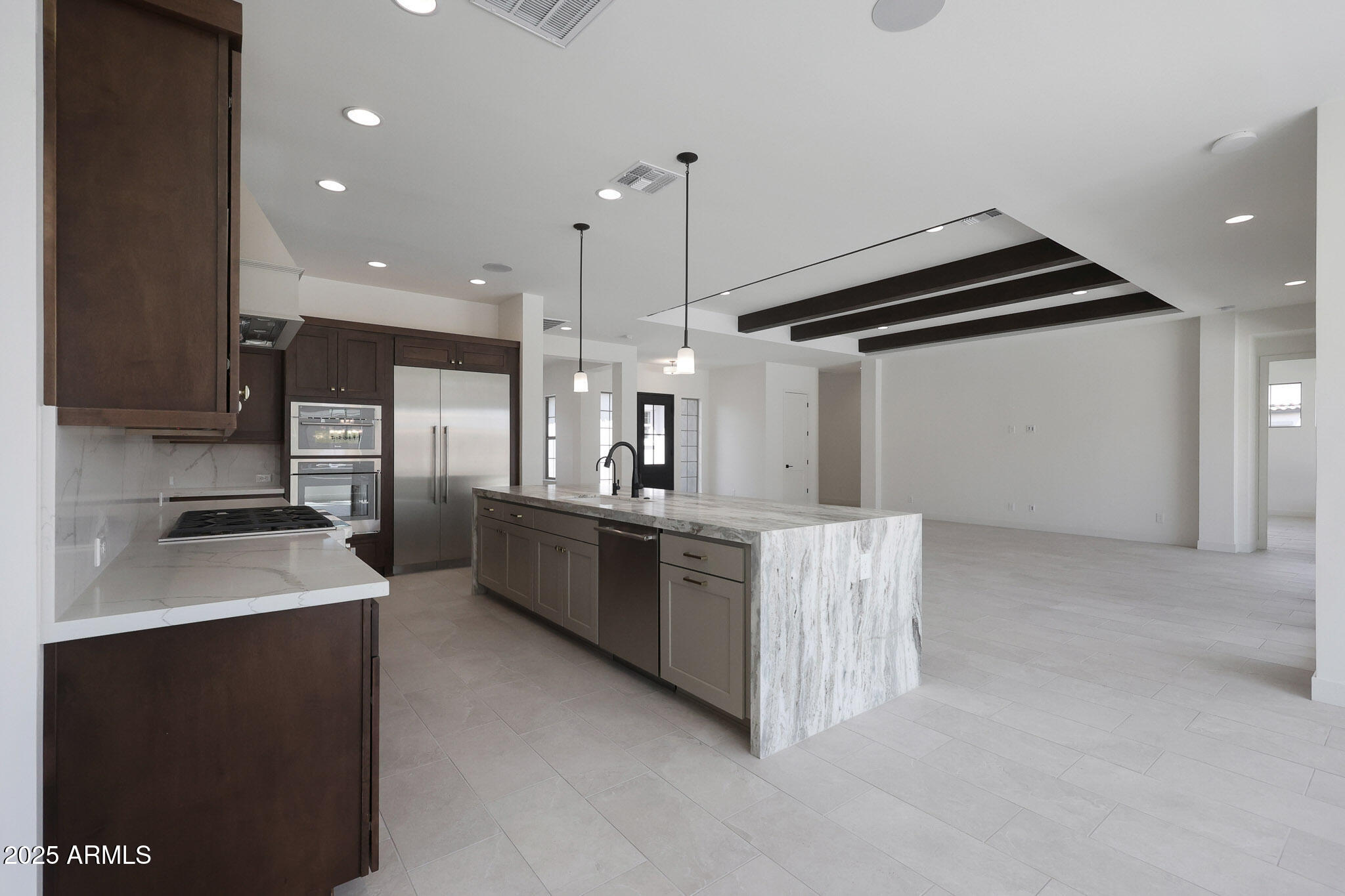 20775 West Rattler Road Buckeye, AZ 85396 - Photo 18 of 90 a kitchen with kitchen island a sink stainless steel appliances and cabinets