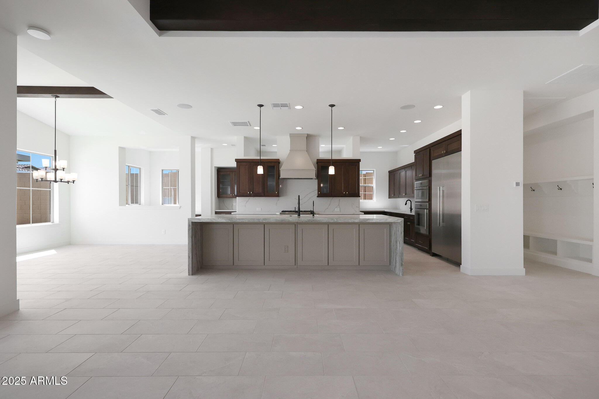 20775 West Rattler Road Buckeye, AZ 85396 - Photo 19 of 90 a large white kitchen with a large window and stainless steel appliances