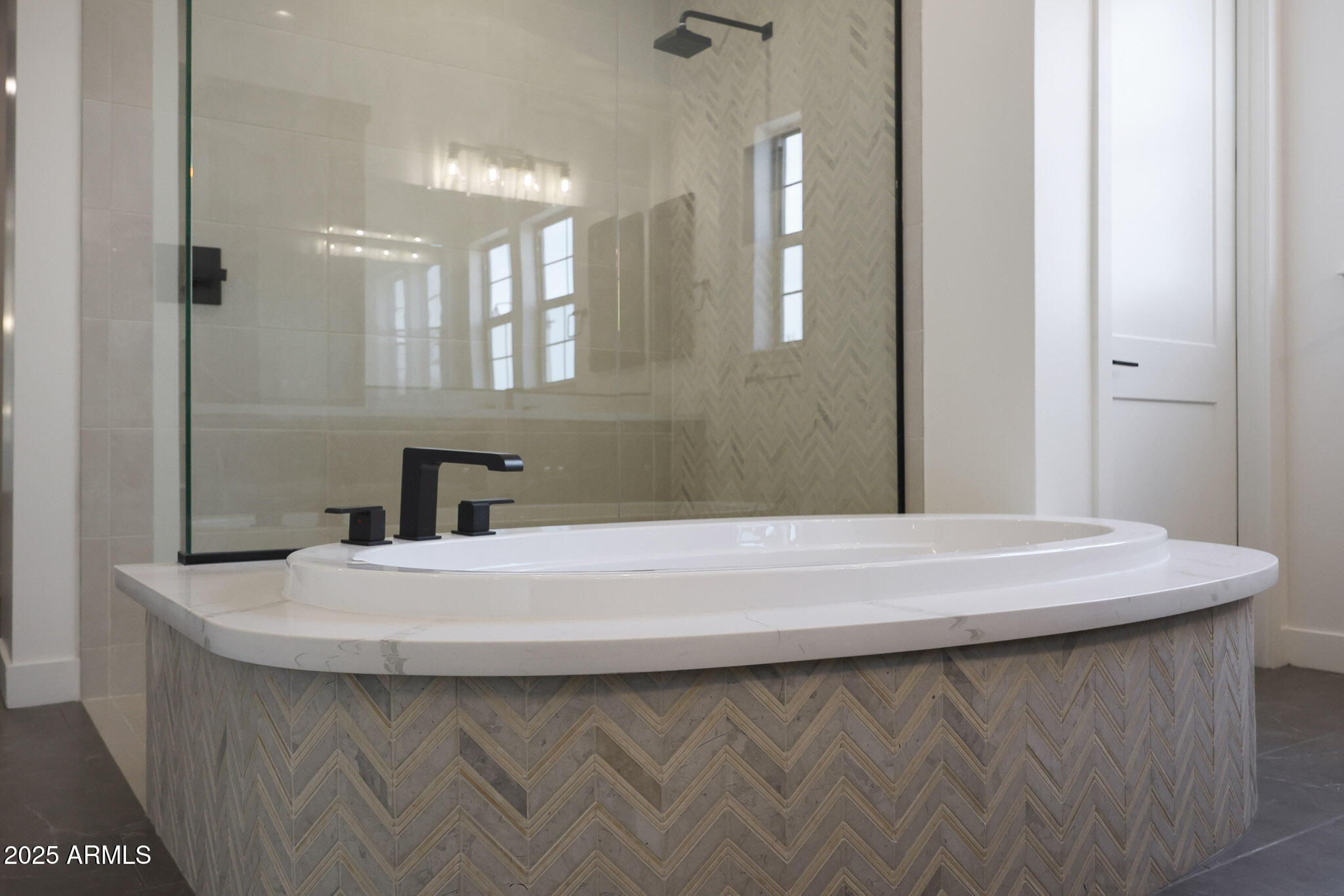 20775 West Rattler Road Buckeye, AZ 85396 - Photo 38 of 90 a bathroom with a sink a mirror and a bathtub
