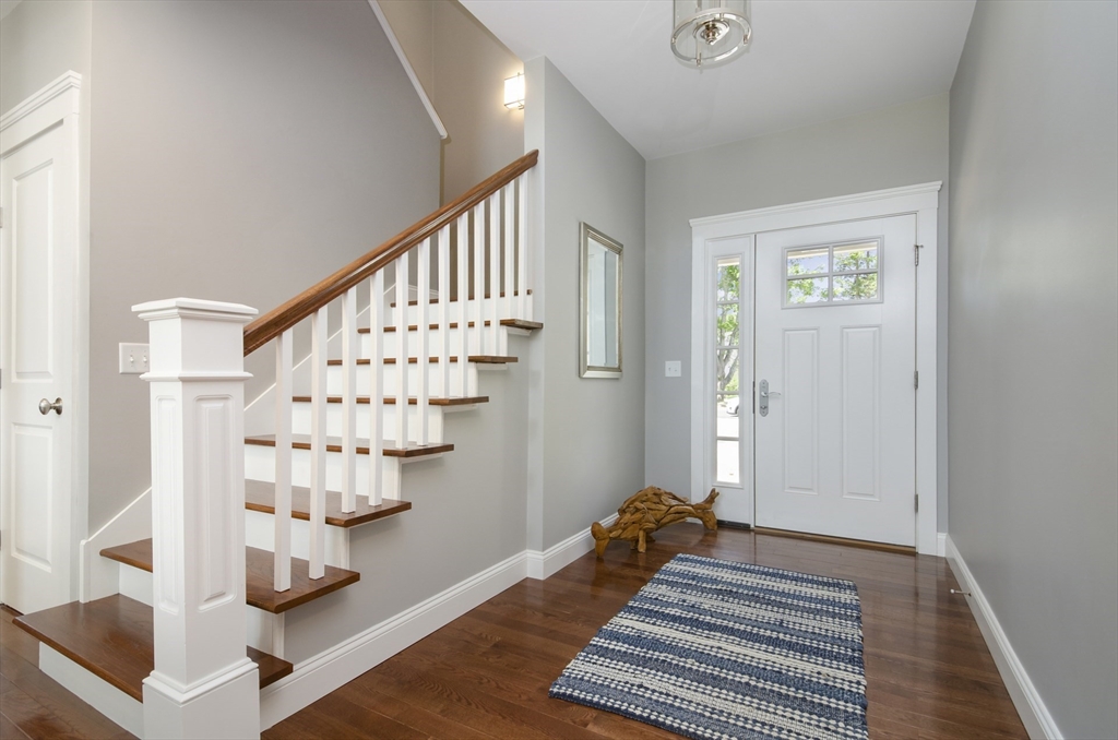 3 Beacon Street, Unit 34 Onset, MA 02558 - Photo 2 of 9 a bedroom with wooden floor and staircase