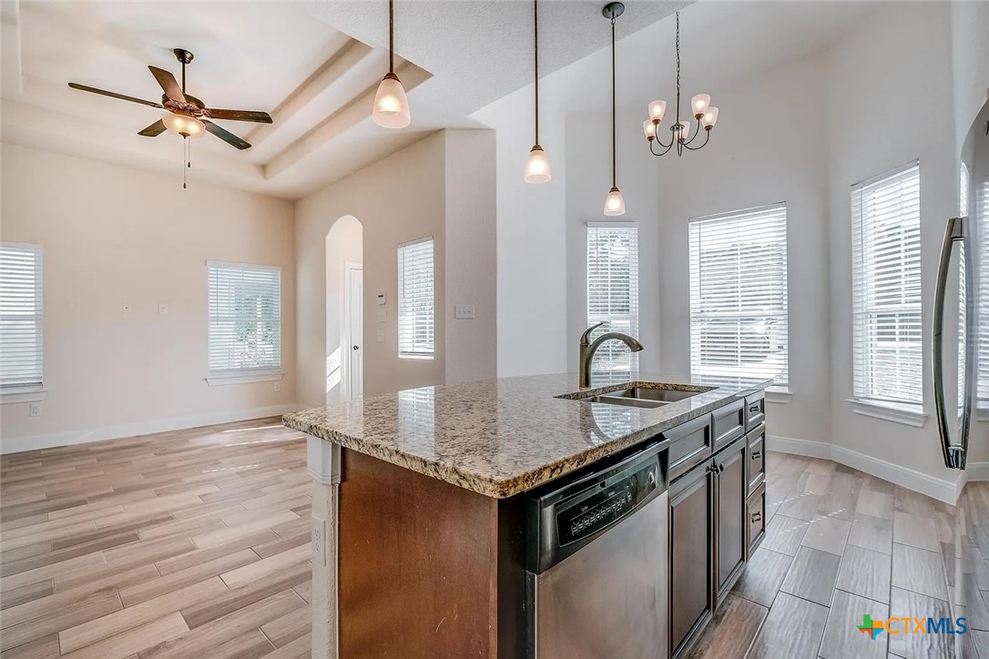 3133 Puter Creek Road, Unit B Spring Branch, TX 78070 - Photo 7 of 19 a hallway with a granite countertop sink a stove and a chandelier