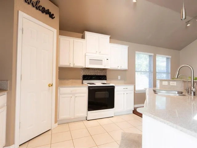 a stove top oven sitting inside of a kitchen