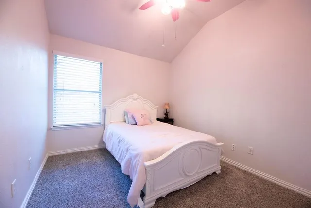 a bedroom with a bed and a night stand