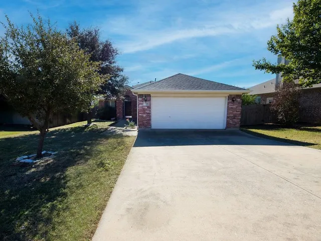 an aerial view of multiple houses with a yard