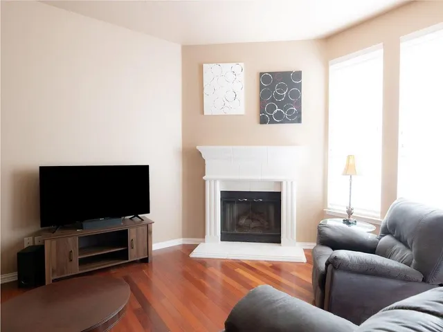 a living room with a fireplace furniture and a wooden floor