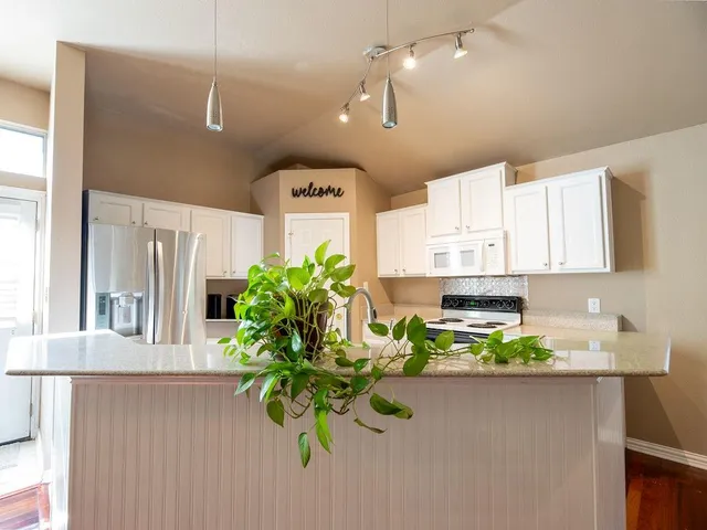a kitchen with a refrigerator and a sink