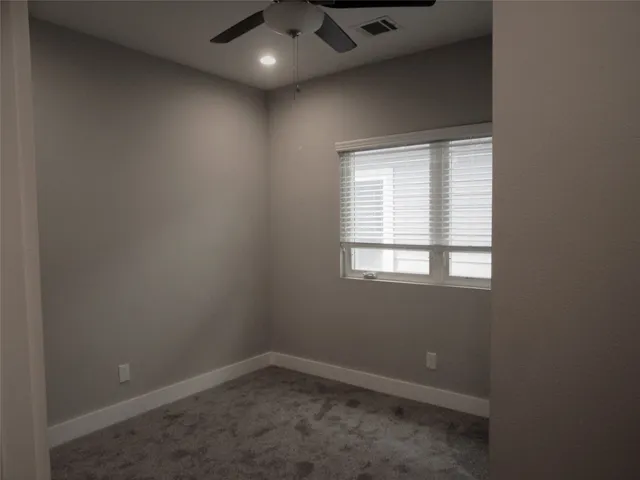 an empty room with a empty space and windows