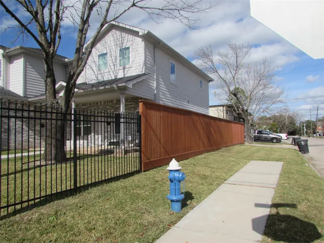a view of a backyard with a large tree