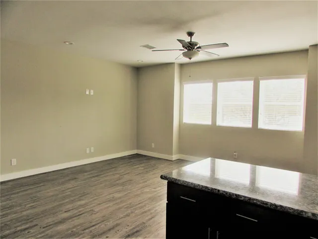 a kitchen with a sink cabinets and wooden floor