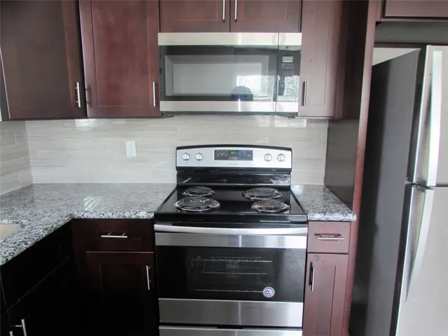 a stove top oven sitting inside of a kitchen
