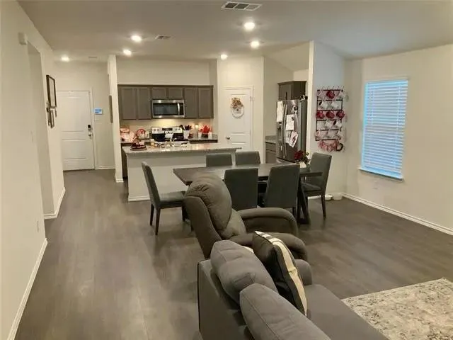 a kitchen with a sink and wooden floor