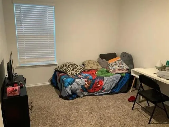 a living room with stainless steel appliances kitchen island granite countertop furniture and a wooden floor