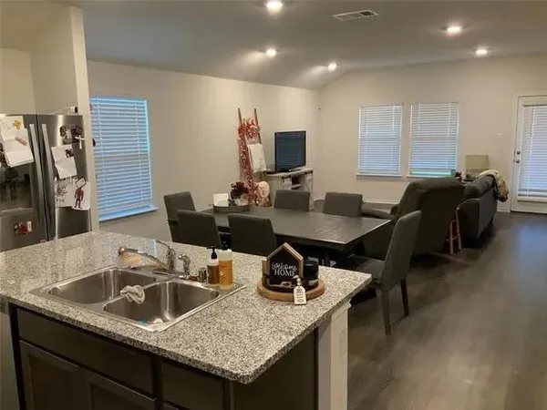 a bathroom with a granite countertop shower toilet and sink