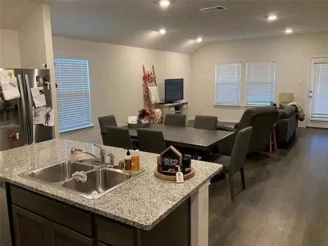 a bathroom with a granite countertop shower toilet and sink