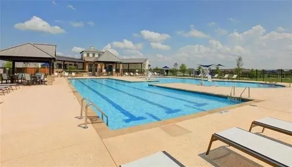 a kitchen with granite countertop a sink a counter and cabinets