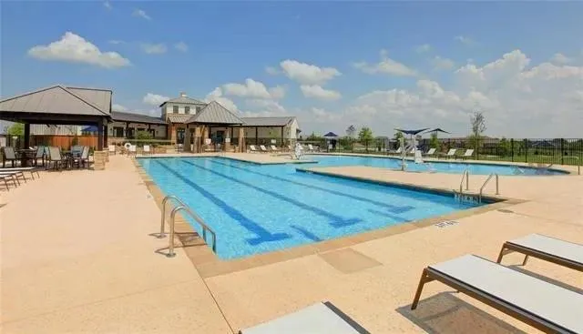a kitchen with granite countertop a sink a counter and cabinets