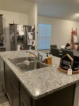 a view of a swimming pool with lawn chairs under an umbrella