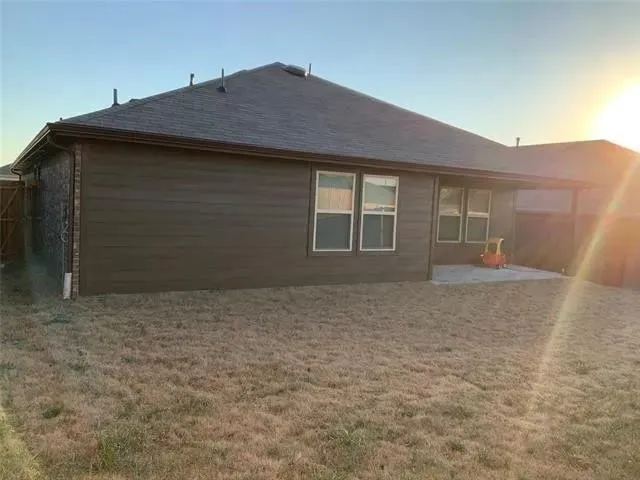 an aerial view of a house with a garden and pathway