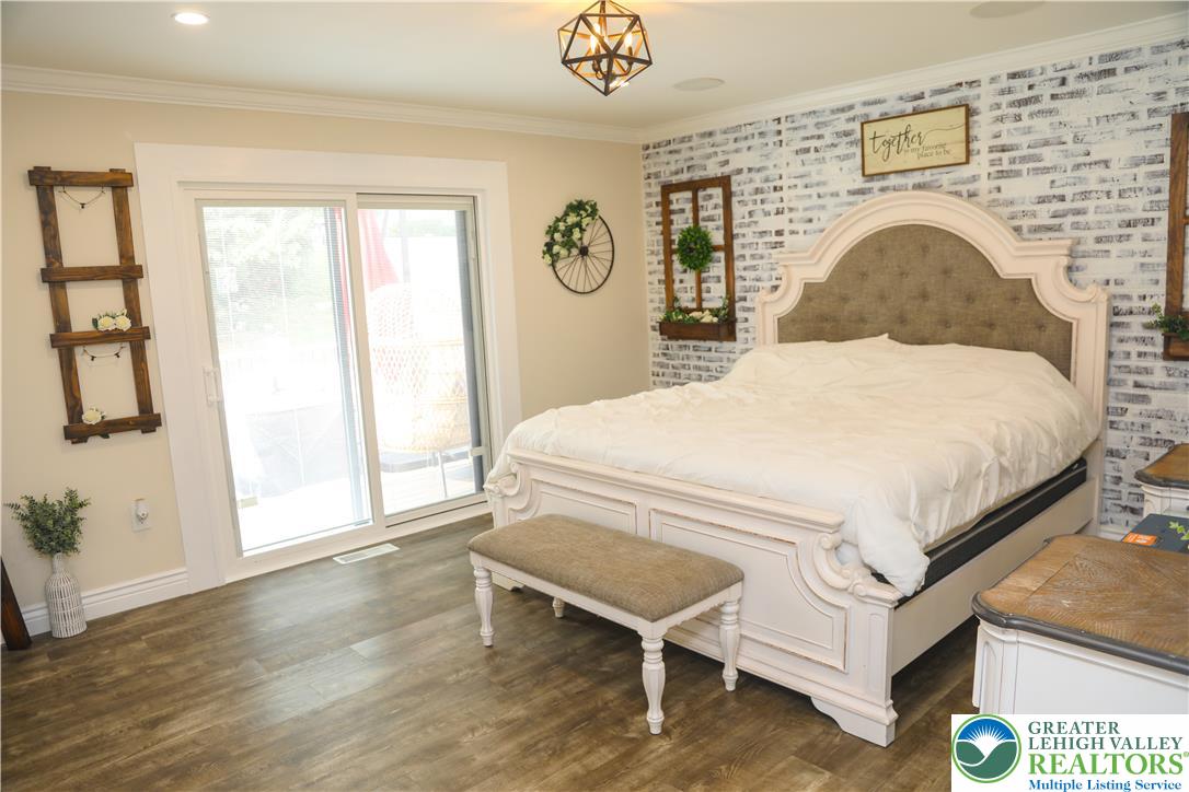 1412 Stanford Road Bethlehem, PA 18018 - Photo 37 of 58 Naturally illuminated bedroom with durable laminate flooring and a direct walkout to outdoor space.
