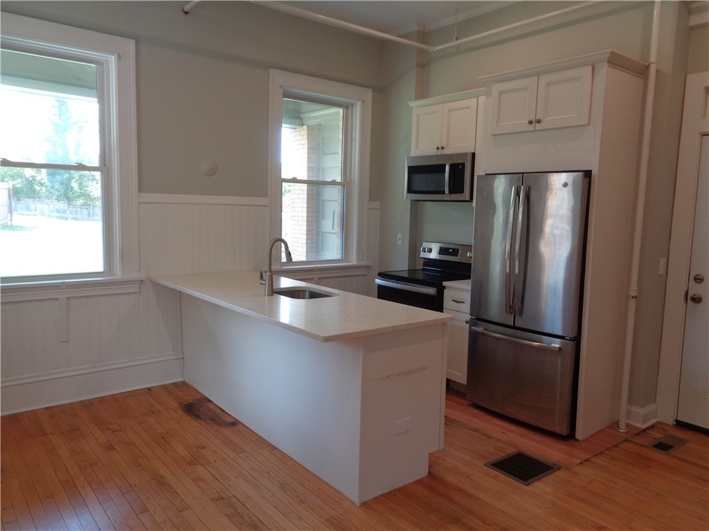 22 West 3rd Street, Unit 102 Corning, NY 14830 - Photo 5 of 19 Kitchen setup, including a breakfast bar