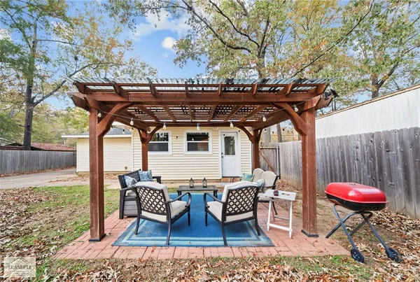 a view of a chairs and table in the backyard