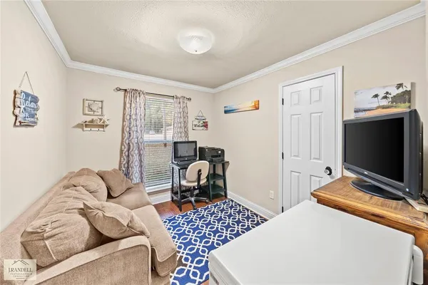 a bedroom with furniture and a flat screen tv
