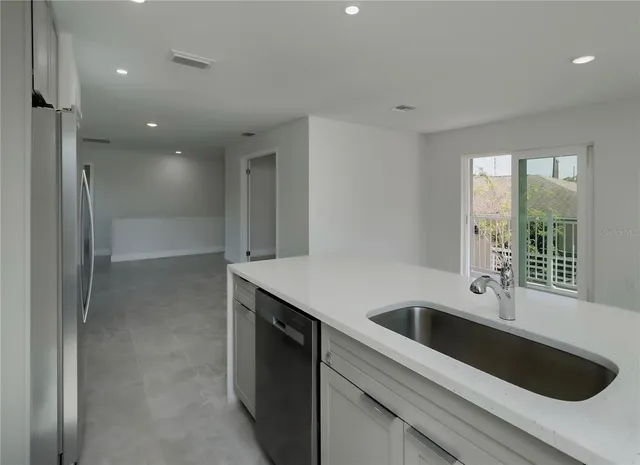 a kitchen with refrigerator and window