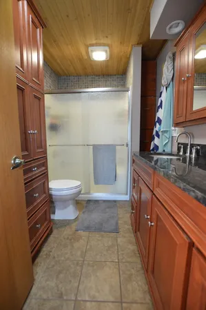 a bathroom with a sink toilet and shower