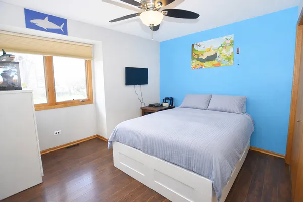 a bedroom with a bed and a chandelier