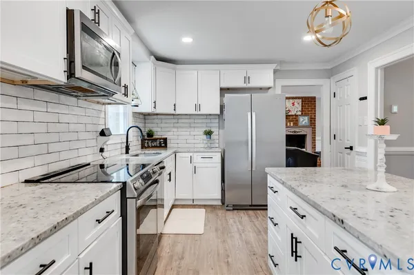 a kitchen with a sink stainless steel appliances and cabinets