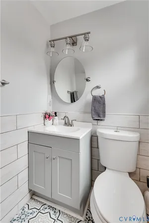 a bathroom with a sink mirror vanity and toilet