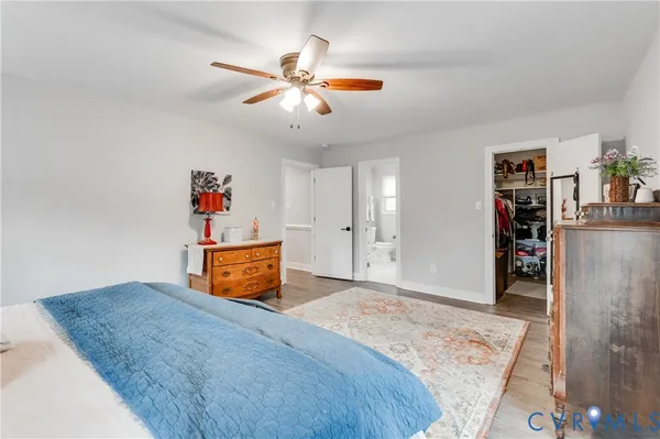 a bathroom with a granite countertop sink a toilet and a mirror