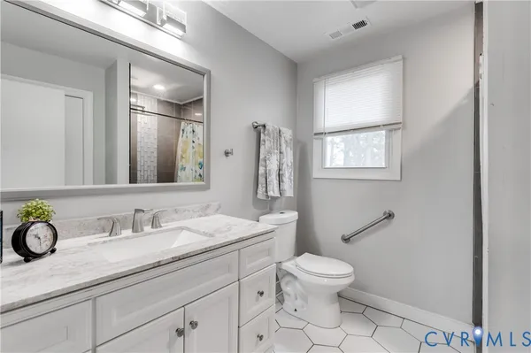 a bathroom with a granite countertop shower and a sink