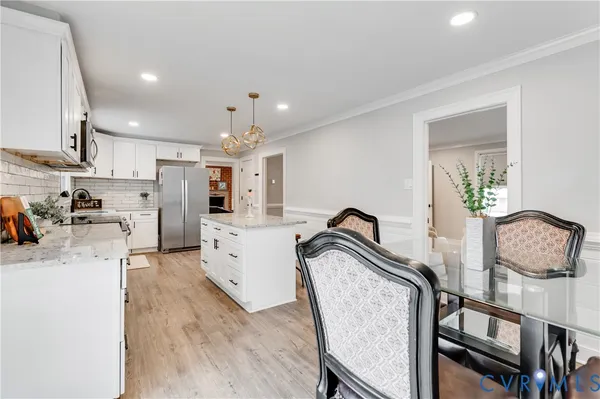 a kitchen with furniture a counter top space a sink stainless steel appliances and cabinets