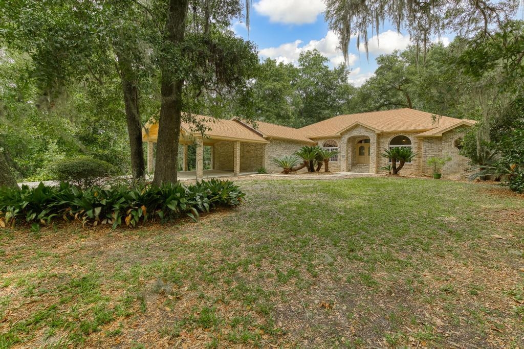 2005 Bennett Road St. Augustine, FL 32092 - Photo 2 of 95 a front view of a house with a yard and trees