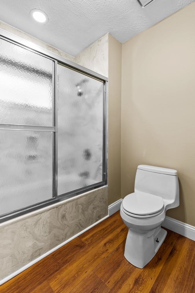 2005 Bennett Road St. Augustine, FL 32092 - Photo 27 of 95 a bathroom with a toilet and a glass shower door