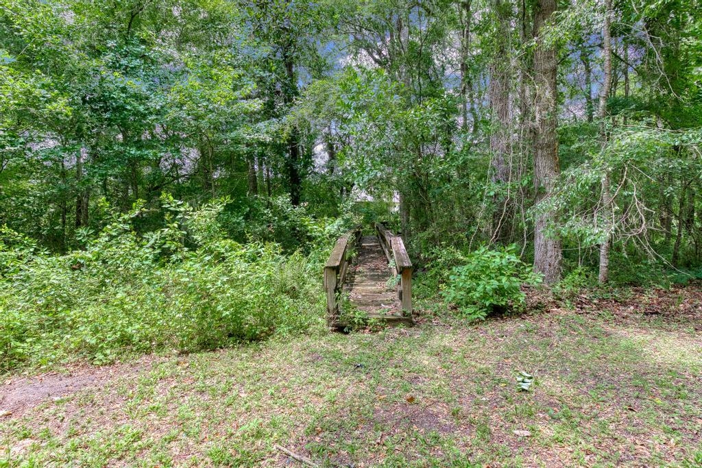 2005 Bennett Road St. Augustine, FL 32092 - Photo 56 of 95 a backyard of a house with lots of green space and chair
