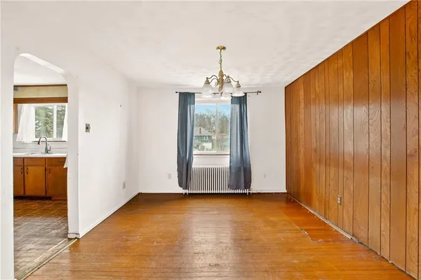 a view of a room with wooden floor and windows