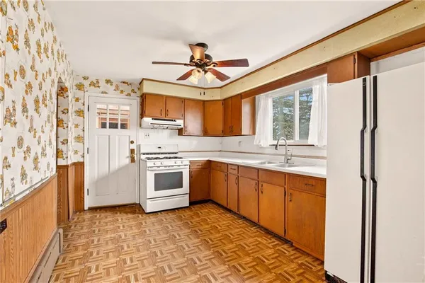 a kitchen with stainless steel appliances granite countertop a stove a sink and a refrigerator