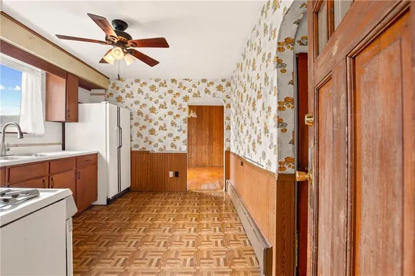 a view of washer and dryer with kitchen in the background