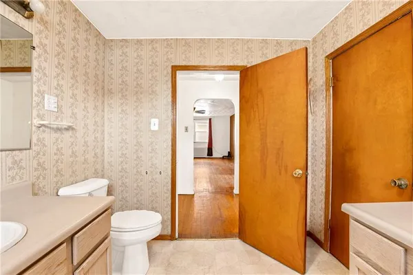 a view of an empty room with window and a ceiling fan