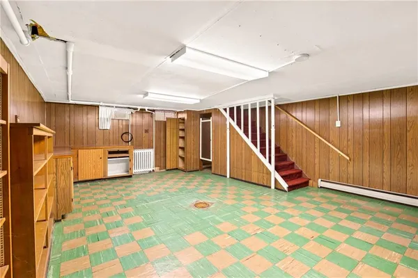 a view of a livingroom with wooden floor and furniture