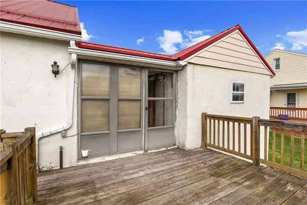a view of a house with a yard and a large tree