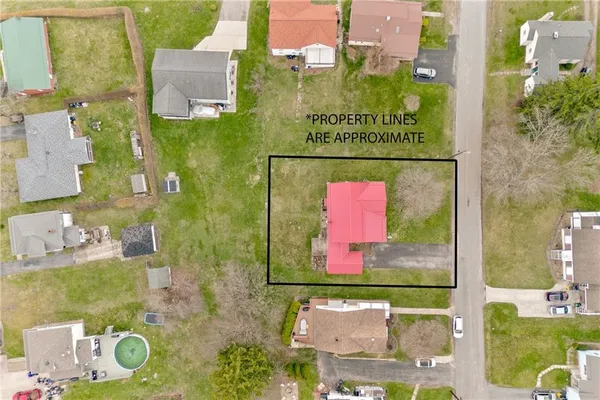 an aerial view of residential houses with outdoor space and street view
