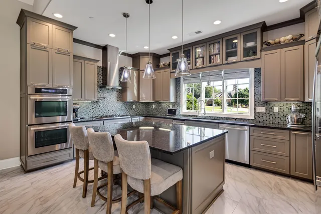 a large kitchen with granite countertop lots of counter space and window