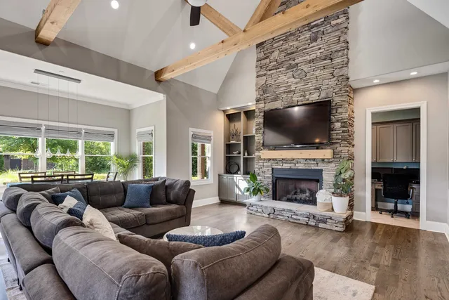 a living room with furniture a fireplace and a flat screen tv