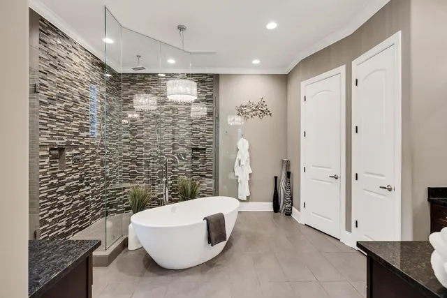 a spacious bathroom with a granite countertop double vanity sink a mirror a and a shower