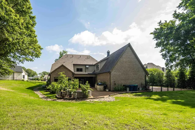 a backyard of a house with lots of green space and trees all around