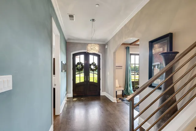 a view of an entryway with wooden floor and livingroom