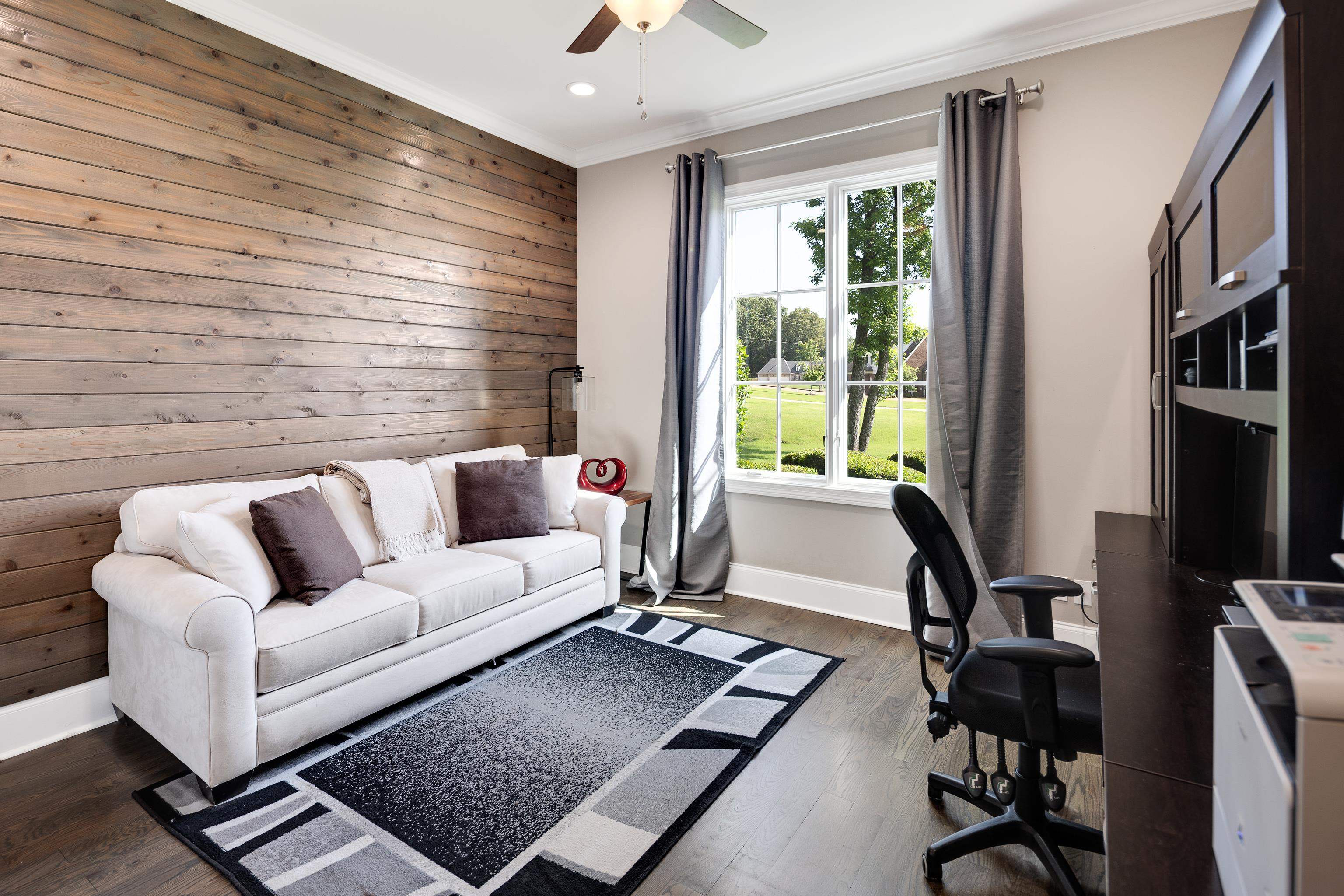 35 Spruce Valley Lane Piperton, TN 38017 - Photo 8 of 39 a living room with furniture gym equipment and a large window